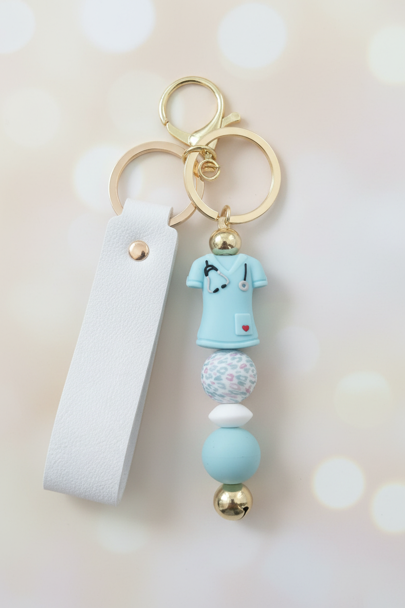 Blue Nurse Scrubs Keychain – Pastel Cream Bokeh